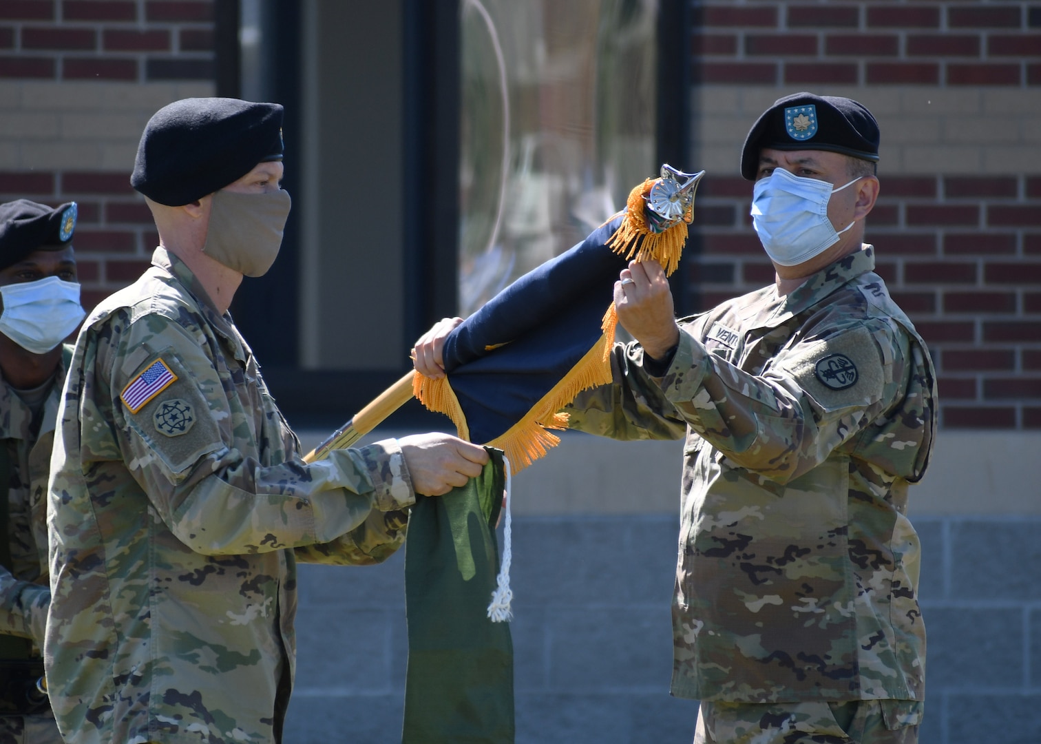 Lt. Col. Robert P. Venton (right) and Command Sgt. Maj. Gordon Lawitzke (left), the commander and senior enlisted leader respectively of the Fort Drum Soldier Recovery Unit, prepare to case the iconic colors of the 3rd Battalion, 85th Mountain Infantry Regiment Warrior Transition Unit (WTU) during a re-designation ceremony on Fort Drum, N.Y. June 16, 2020.