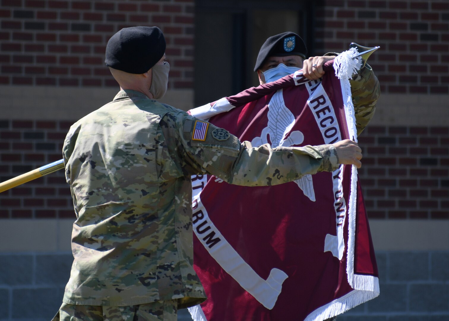 Lt. Col. Robert P. Venton (right) and Command Sgt. Maj. Gordon Lawitzke (left), the commander and senior enlisted leader respectively of the Fort Drum Soldier Recovery Unit, uncase the colors of the newly formed Fort Drum Soldier Recovery Unit (SRU) during a ceremony on Fort Drum, N.Y. June 16, 2020.