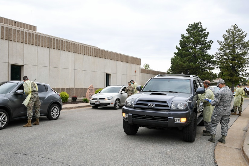 Airmen conduct two lanes of drive-thru COVID-19 screening and testing.