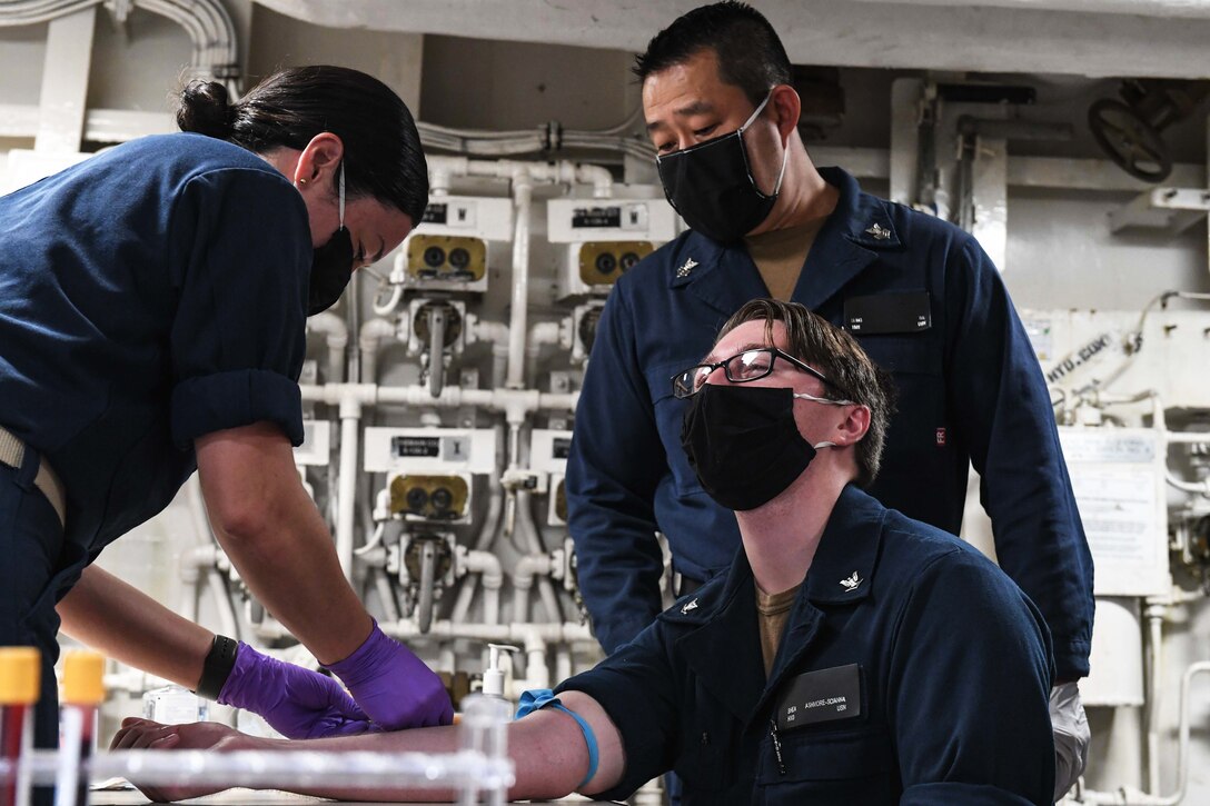 A sailor has blood drawn for an antibody test.