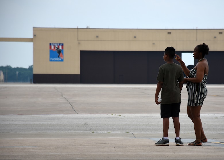 A pair of festival goers look out the hangar doors at the Juneteenth Festival on Whiteman Air Force Base, Mo.