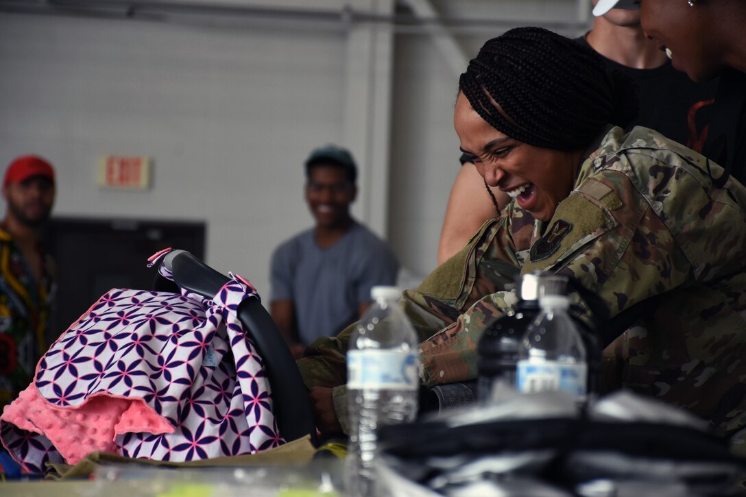 An Airman plays with a baby at the Juneteenth Festival on Whiteman Air Force Base, Mo.