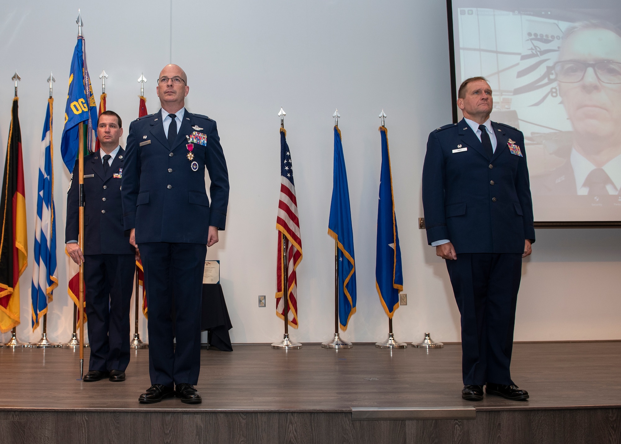 Driggers and Haas stand at attention during change of command ceremony