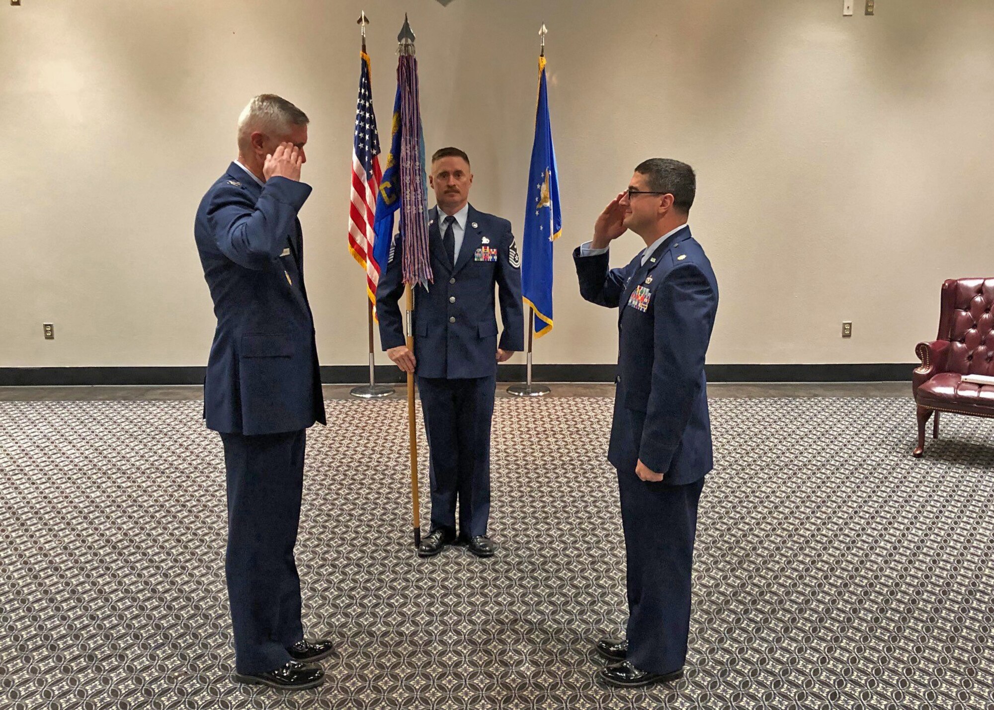 U.S. Air Force Col. Tony England, 17th Mission Support Group commander and Maj. Christopher Higgins, 17th Civil Engineering Squadron incoming commander, salute each other at the 17th CES Assumption of Command ceremony, at the event center on Goodfellow Air Force Base, Texas, June 22, 2020.  The ceremony held less than 10 people to adhere to social distancing and COVID-19 restrictions. (courtesy photo)