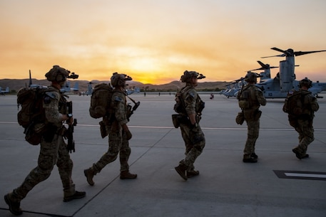 U.S. Marines with U.S. Marine Corps, Special Operations Command prepare to board MV-22B Osprey