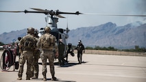 A photo of Airmen preparing to board a helicopter