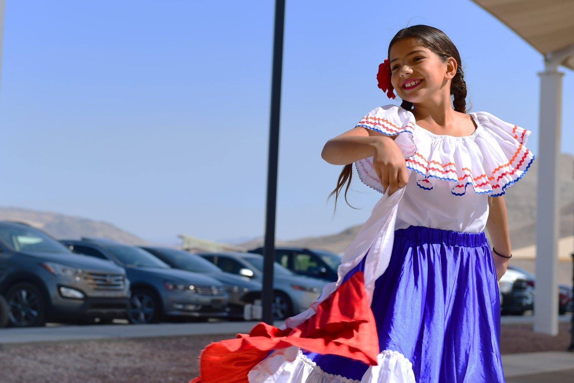 A Hunter family member dances during a Hispanic Heritage month celebration at Creech Air Force Base