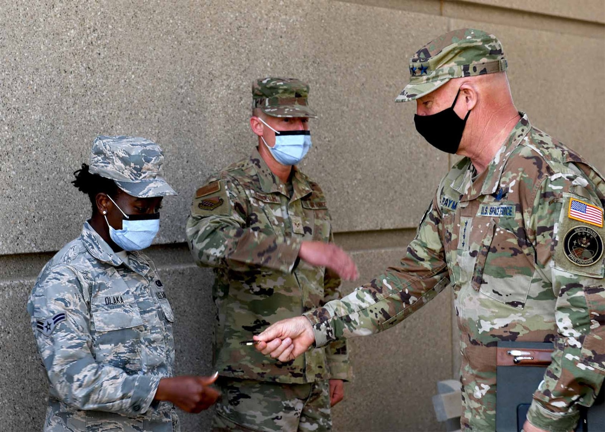 Gen. Jay Raymond, U.S. Space Force Chief of Space Operations and U.S. Space Command commander,  recognizes Airman 1st Class Mercy Olaka, 140th Force Support Squadron services craftsman, for outstanding performance, during his visit to Buckley Air Force Base, Colo., June 17, 2020. Olaka served 2,000 meals per week for approximately 90 mission-essential personnel and conducted routine safety screenings to minimize COVID exposure within the dining facility. (U.S. Air Force photo by Airman 1st Class Andrew I. Garavito)