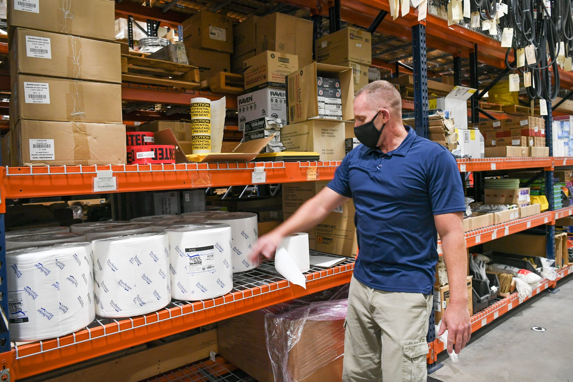 Brad Reed, 309th Maintenance Support Group material inventory center supervisor, browses the shelves of additional cleaning and protective supplies the group ordered due to COVID-19.