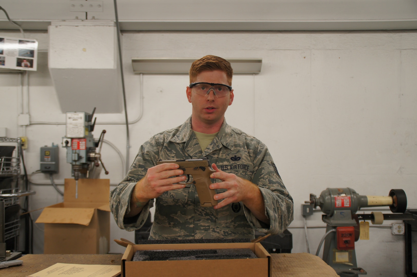 Tech. Sgt. Brady Craddock, non-commissioned officer in charge of the Air Force Gunsmith Shop, explains the benefits of the M18 modular handgun system. The Air Force Security Forces Center, in partnership with the Air Force Small Arms Program Office, has begun fielding the new M18 to Security Forces units.(U.S. Air Force photo by Vicki Stein/Released)