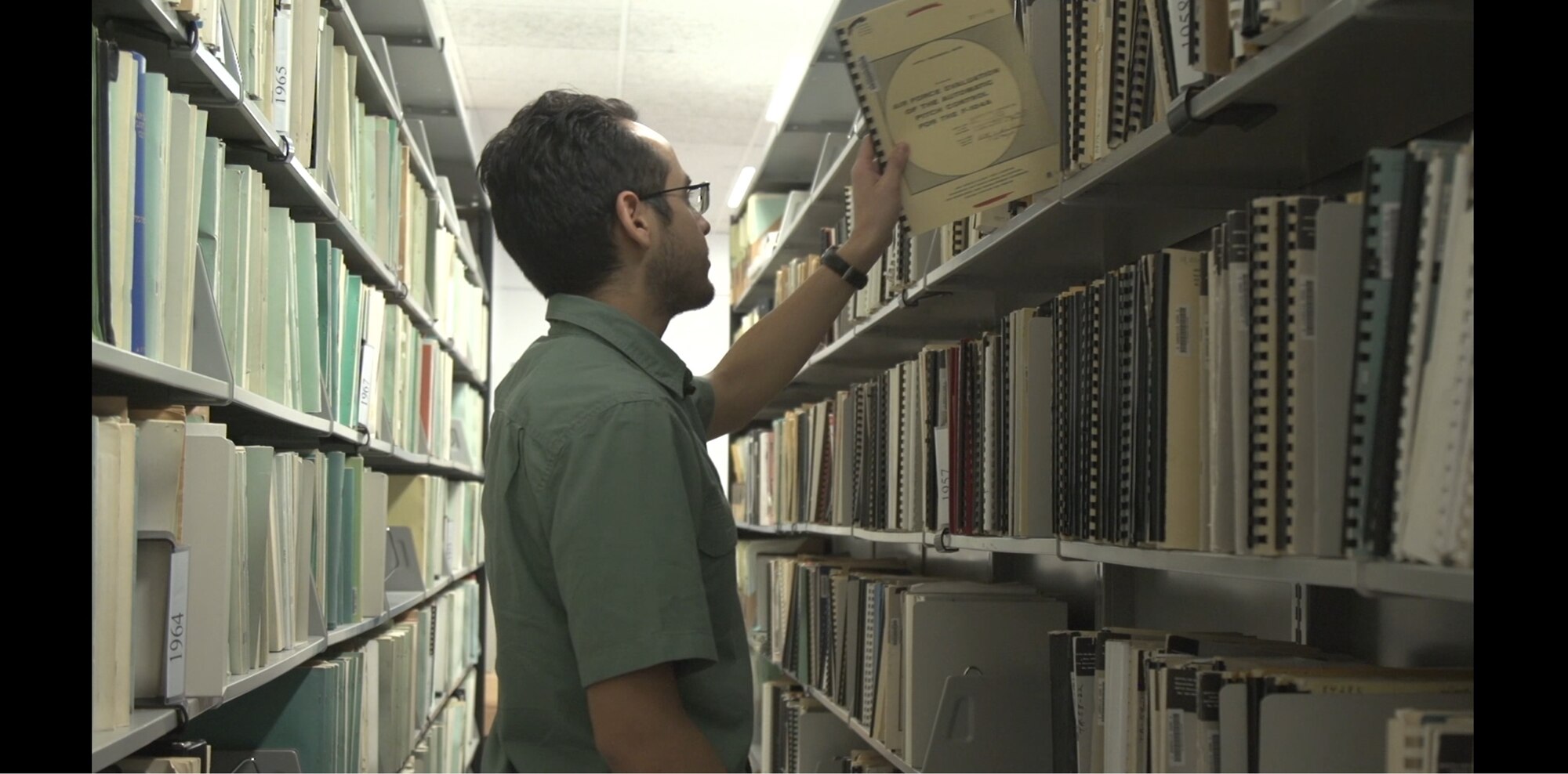 An Edwards Air Force Base engineer consults a Technical Report in the 812th Test Support Squadron archives. The Scientific and Technical Information Program Distribution Statements identify who may view the contents of a report and are prominently displayed on the front cover. (Courtesy photo)