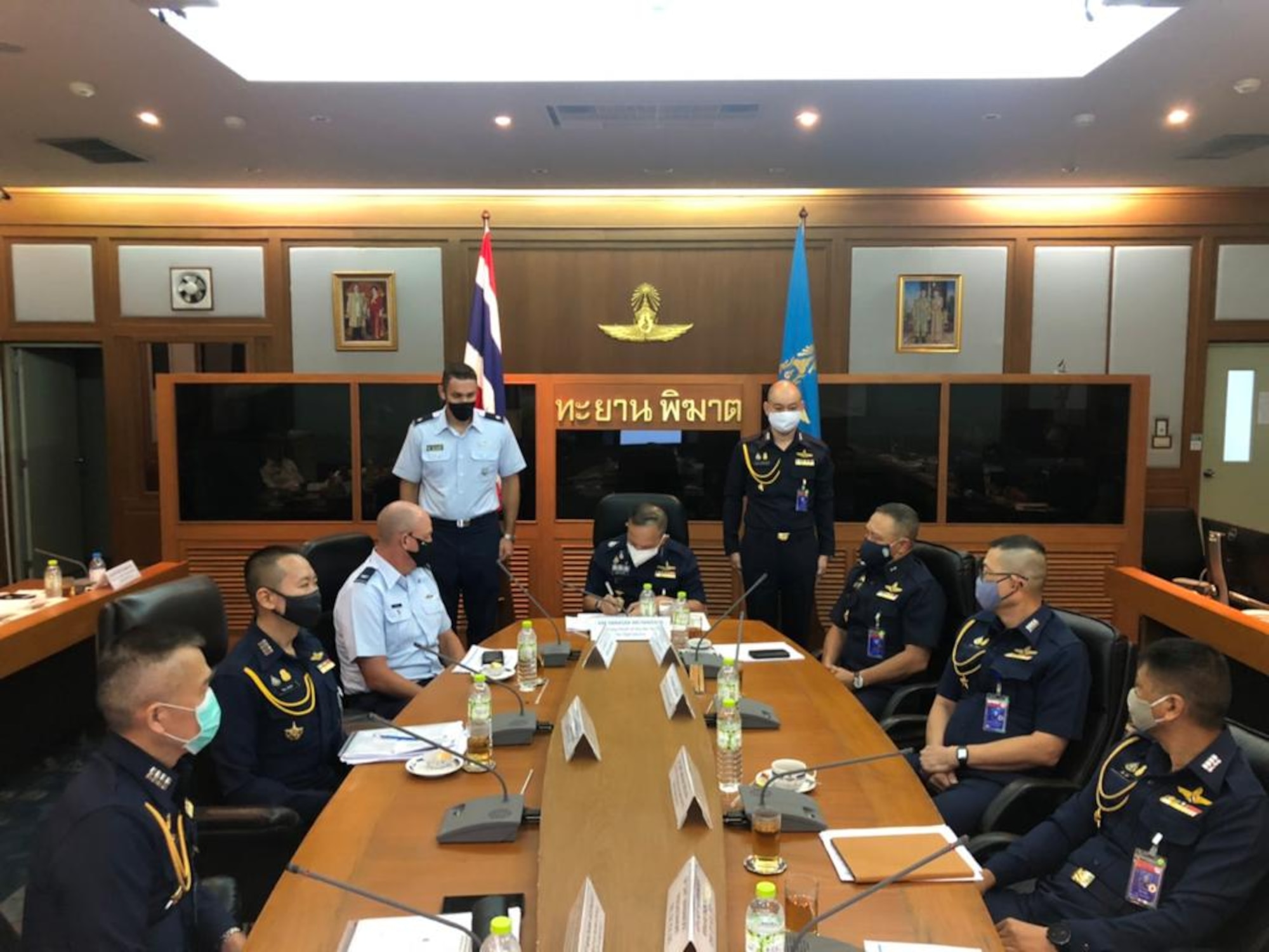 Royal Thai Air Force Air Marshal Tanasak Metananta, deputy chief of the Air Staff, signs the Airman-to-Airman Talks minutes during the final moments of the four-day event, June 18, 2020. Due to the Coronavirus, the annual talks took place virtually for the first time, June 15 through 18; discussing  aerospace medicine, logistics, air domain awareness, information security and cyber defense. (Courtesy photo)