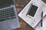 Stock photo of a desk with laptop and mobile phone