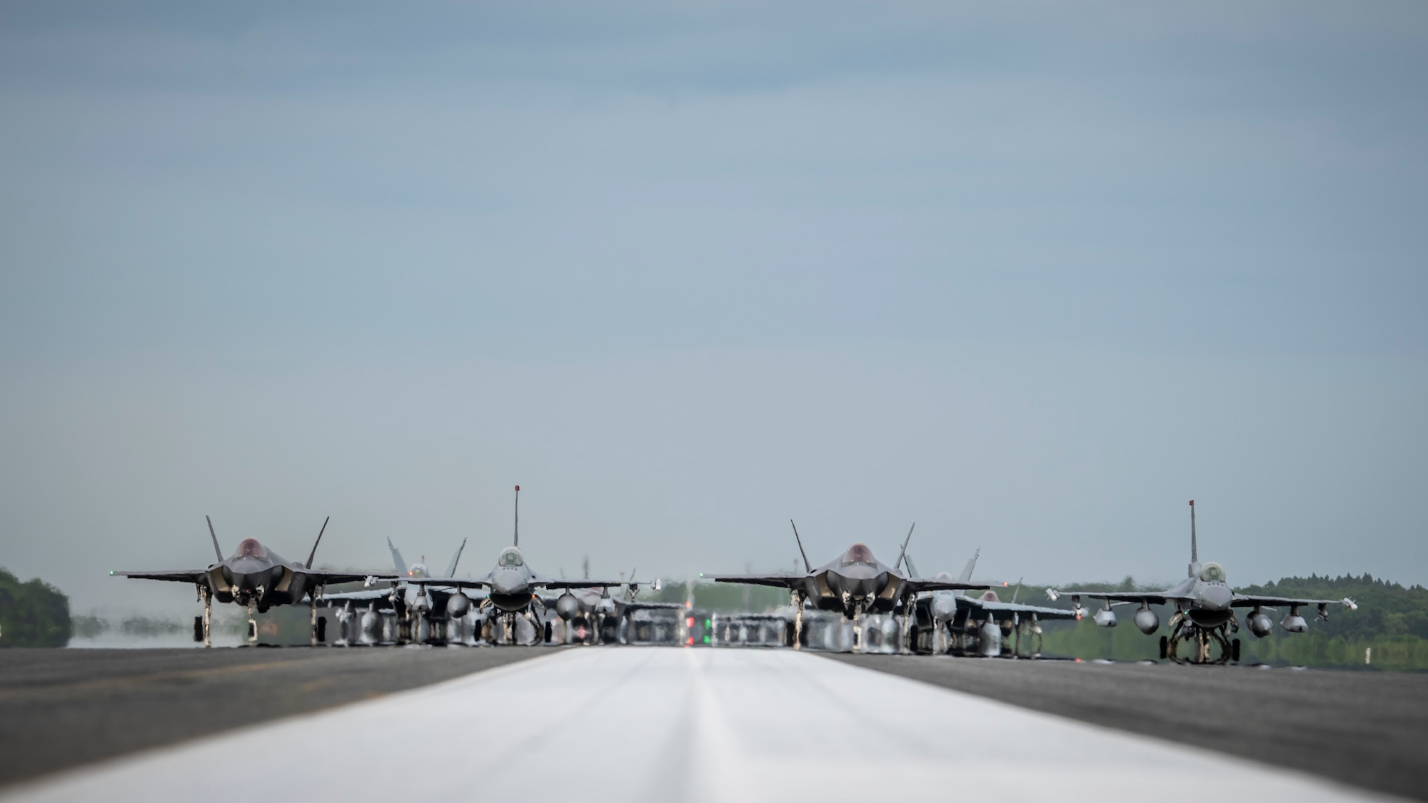 Twelve U.S. Air Force F-16CM Fighting Falcons, 12 Koku-Jieitai F-35A Lightning II Joint Strike Fighters, two U.S. Navy EA-18G Growlers, a USN C-12 Huron, two USAF MC-130J Commando II aircraft, and a USN P-8 Poseidon participate in an “Elephant Walk” at Misawa Air Base, June 22, 2020. The Elephant Walk showcased Misawa Air Base’s collective readiness and ability to generate combat airpower at a moment's notice to ensure regional stability throughout the Indo-Pacific. This is Misawa Air Base’s first time hosting a bilateral and joint Elephant Walk. (U.S. Air Force photo by Airman 1st Class China M. Shock)