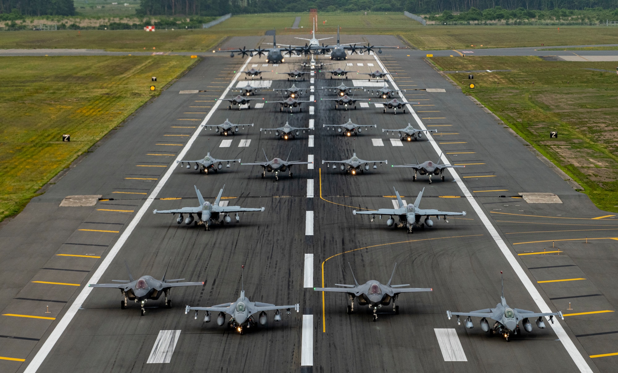Twelve U.S. Air Force F-16CM Fighting Falcons, 12 Koku-Jieitai F-35A Lightning II Joint Strike Fighters, two U.S. Navy EA-18G Growlers, a USN C-12 Huron, two USAF MC-130J Commando II aircraft, and a USN P-8 Poseidon participate in an “Elephant Walk” at Misawa Air Base, June 22, 2020.
