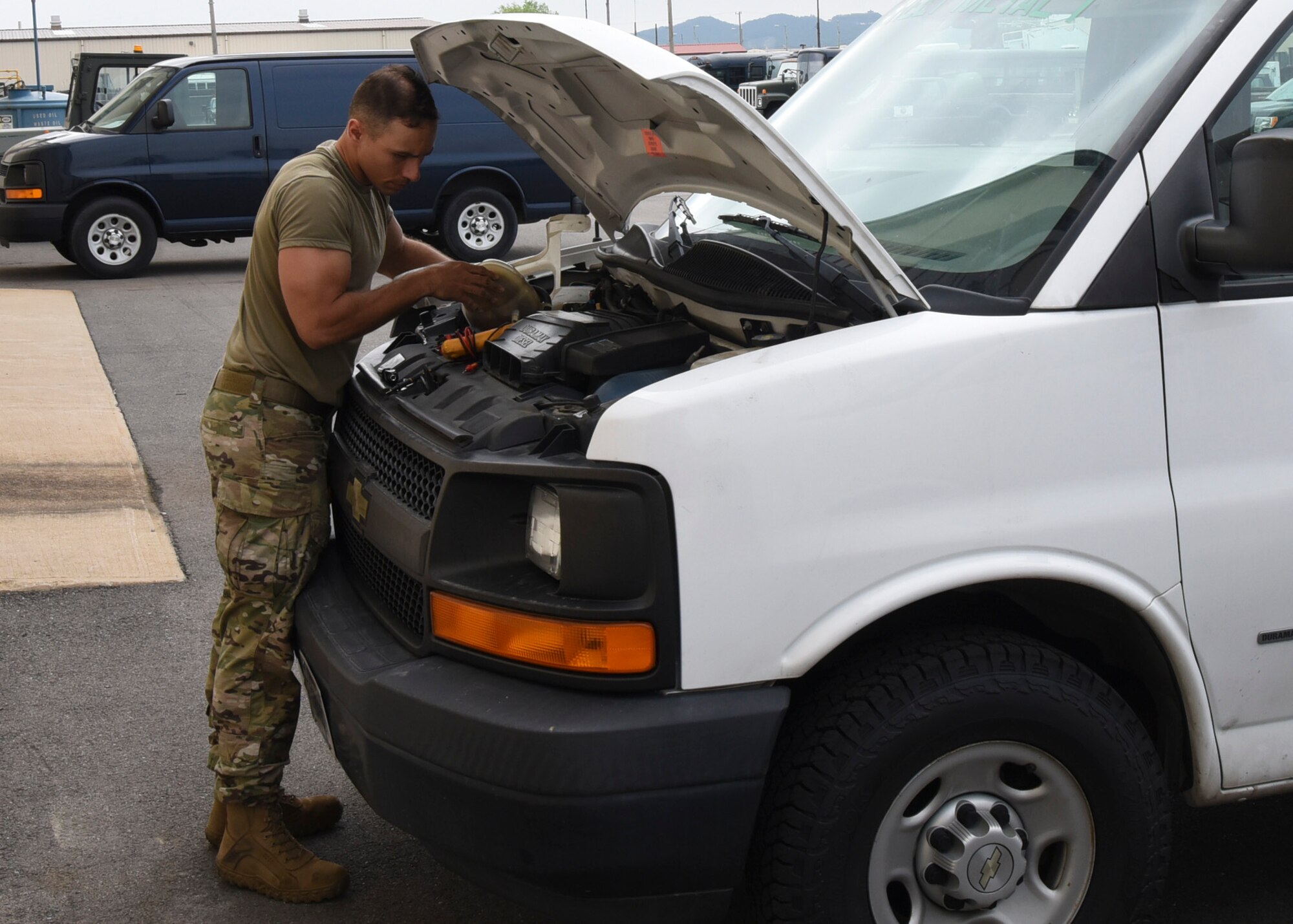 Tech. Sgt. John Bishop, 8th Logistics Readiness Squadron NCO in charge of vehicle maintenance, removes the coolant from a vehicle to inspect its sensor at Kunsan Air Base, Republic of Korea, June 4, 2020. Bishop is troubleshooting a low coolant light on the vehicle by checking the voltage to ensure the sensor is getting power. (U.S. Air Force photo by Staff Sgt. Anthony Hetlage)