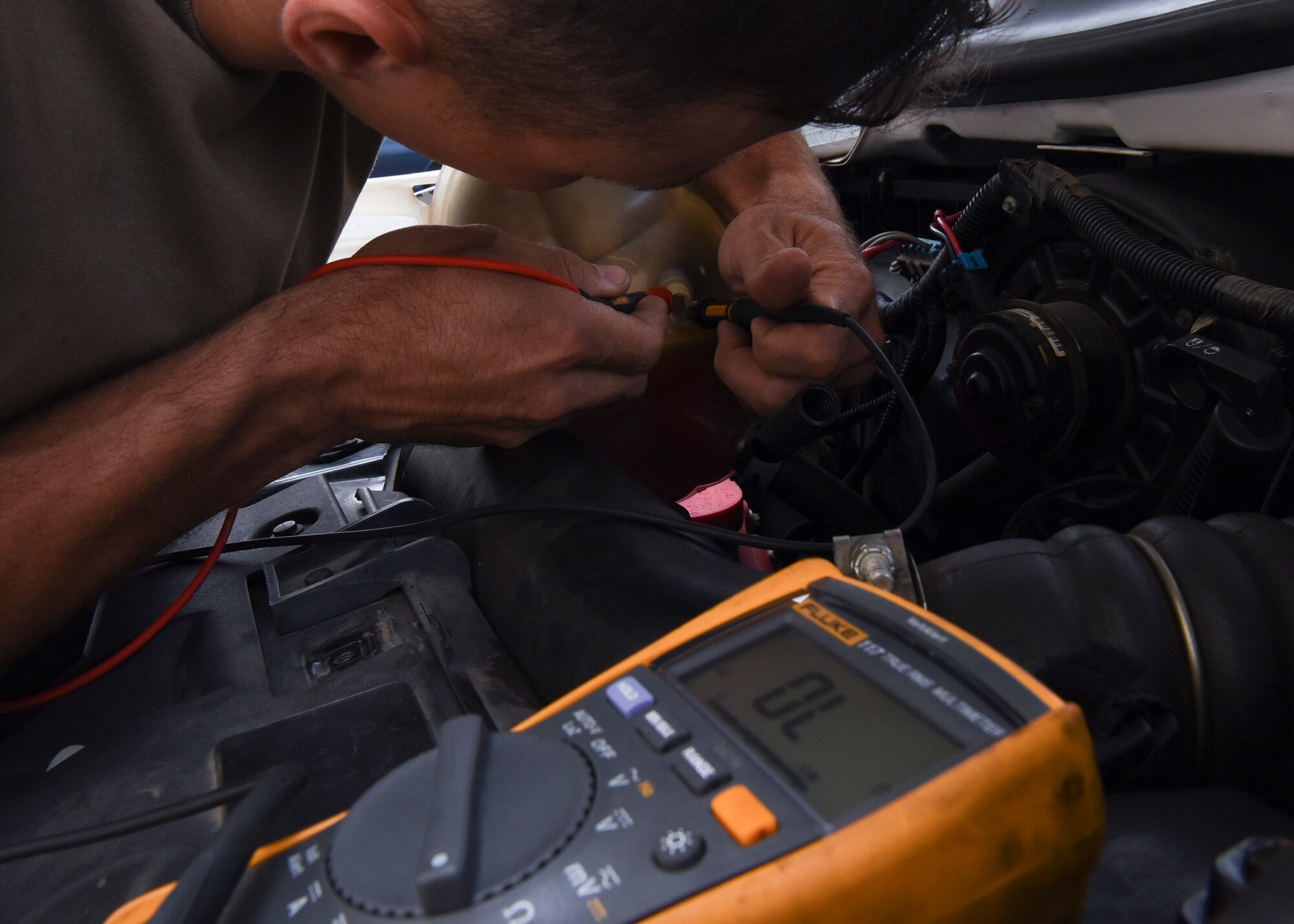Tech. Sgt. John Bishop, 8th Logistics Readiness Squadron NCO in charge of vehicle maintenance, inspects a vehicle at Kunsan Air Base, Republic of Korea, June 4, 2020. Bishop is troubleshooting a low coolant light on the vehicle by checking the voltage to ensure the sensor is getting power. (U.S. Air Force photo by Staff Sgt. Anthony Hetlage)