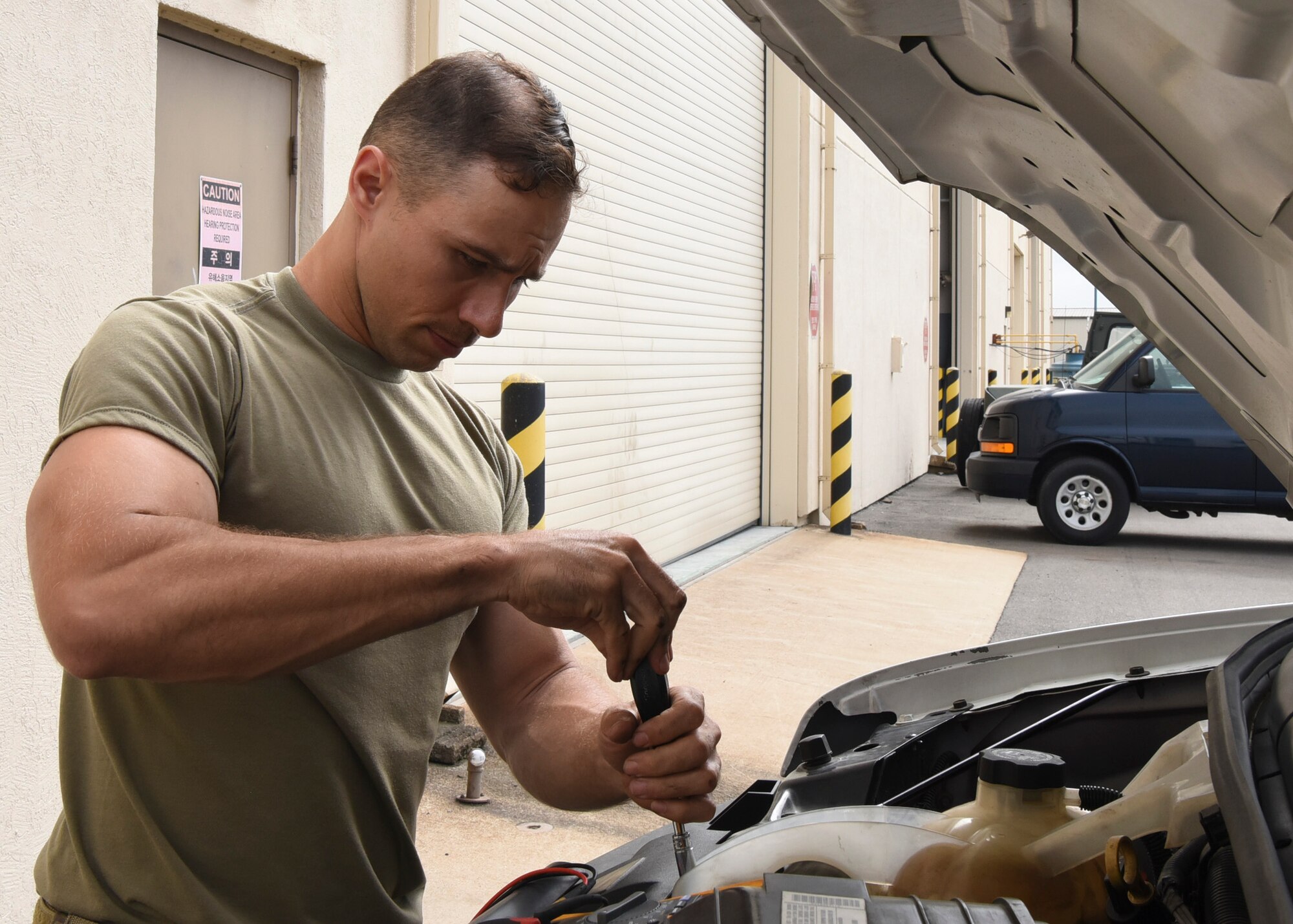 Tech. Sgt. John Bishop, 8th Logistics Readiness Squadron NCO in charge of vehicle maintenance, attaches the coolant reservoir to a truck at Kunsan Air Base, Republic of Korea, June 4, 2020. The unit helps maintain 485 vehicles across the Wolf Pack. (U.S. Air Force photo by Staff Sgt. Anthony Hetlage)
