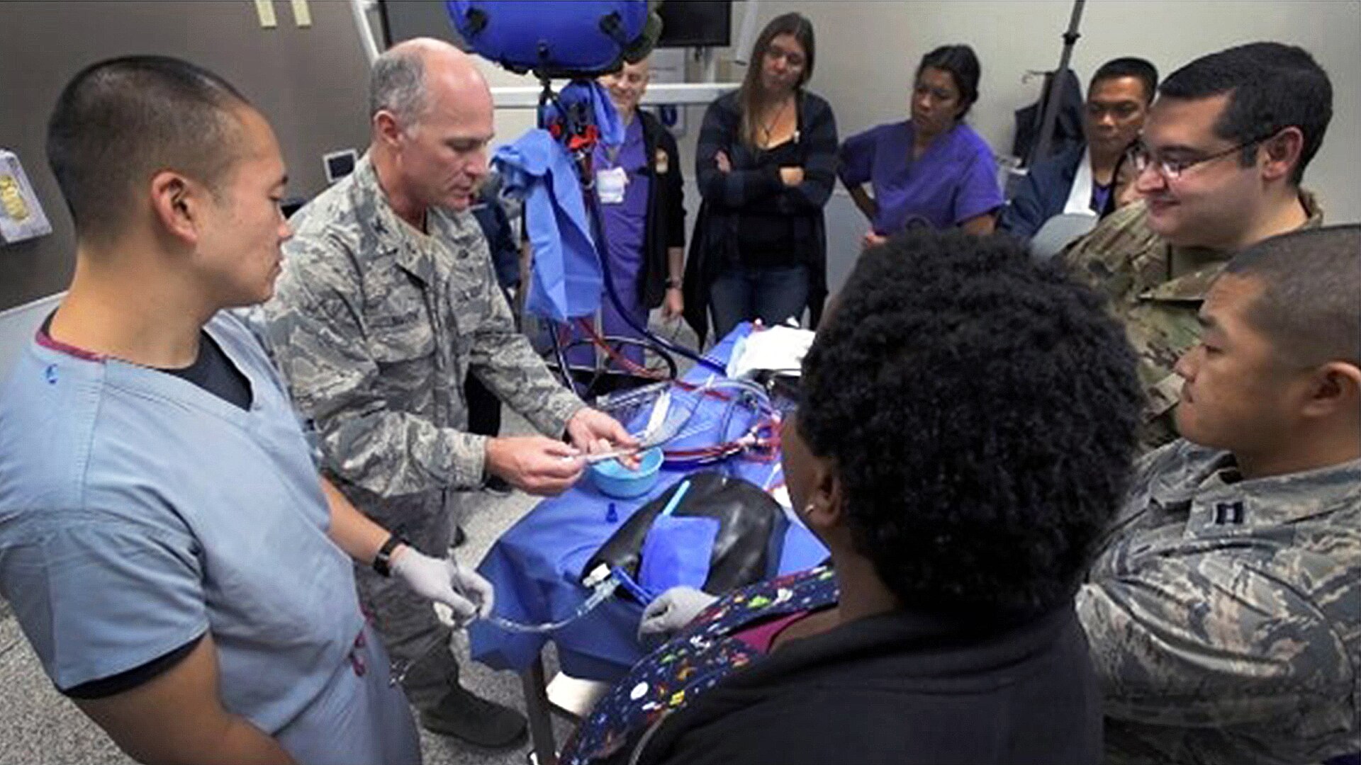 Air Force Col. (Dr.) Phillip Mason, medical director, Brooke Army Medical Center Adult ECMO Program, and other BAMC personnel instruct medical staff on proper extracorporeal membrane oxygenation, or ECMO, cannulation technique at Naval Medical Center San Diego, Dec. 11, 2019.