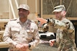 U.S. Army Lt. Col. Shawn Tabankin, the Chief of Plans for Task Force Spartan, shows Col. Raed al Alsakran, Chief of Plans for the Kuwaiti Land Forces, a mobile command post in Kuwait on June 8, 2020. This meeting allows U.S. Forces and Kuwaiti Land Forces to share ideas and best practices. (U.S. Army National Guard photo by Sgt. Trevor Cullen)