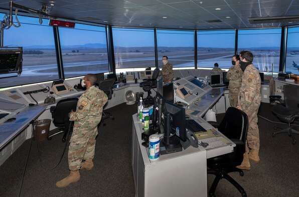 U.S. Air Force air traffic controllers watch the airfield while wearing cloth face coverings May 5, 2020, at Travis Air Force Base, California. The coronavirus pandemic has had a minimal impact on the Travis AFB control tower team’s 24/7mission. Air traffic controllers promote the orderly, safe and expeditious flow of air traffic under both visual and instrument controls by issuing advisories, instructions and clearances. (U.S. Air Force photo by Heide Couch)