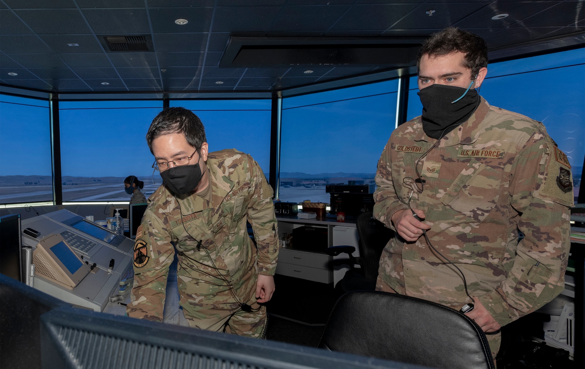 U.S. Air Force Staff Sgt. Drew Tsubota, left, 60th Operation Support Squadron air traffic control journeyman and Staff Sgt. Shane Goldstedt, right, 921st Contingency Response Squadron ATC journeyman, monitor aircraft in the control tower May 5, 2020, Travis Air Force Base, California. The coronavirus pandemic has had a minimal impact on the Travis Control Tower team’s 24/7mission. Air traffic controllers promote the orderly, safe and expeditious flow of air traffic under both visual and instrument controls by issuing advisories, instructions and clearances. (U.S. Air Force photo by Heide Couch)