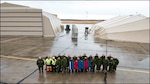Members of 4 Wing, Cold Lake, Alberta, stand in front of a newly assembled Expeditionary Forces Aircraft Shelter System (EFASS) and a Mobile Support Shelter – Aircraft (MSS – A), in the fall of 2019.