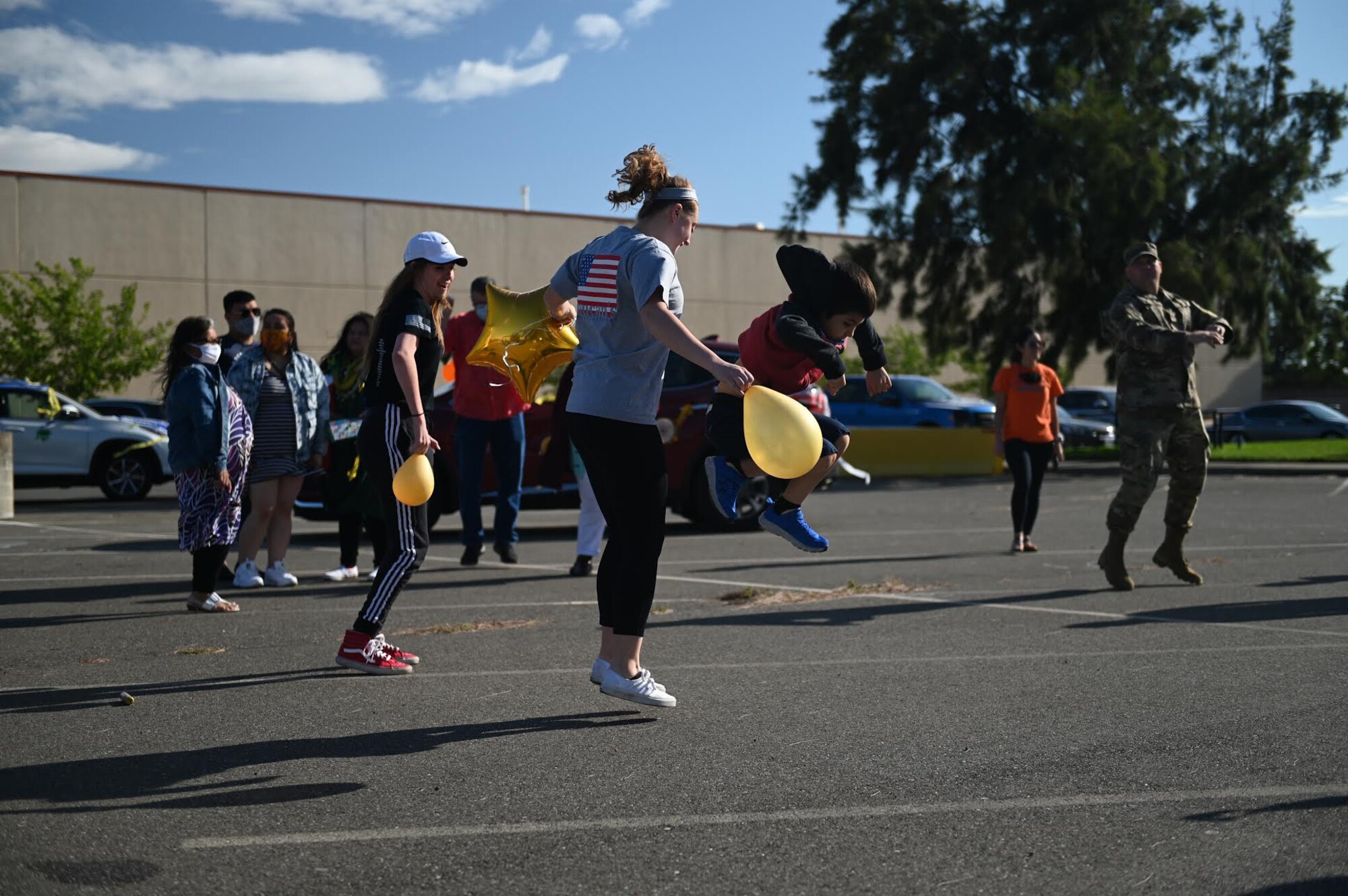 Members of Team Travis conclude the “honk at a grad” parade at the Airman and Family Readiness Center parking lot, June 12, 2020, at Travis Air Force Base, California. The base’s local Air Force Sergeants Association Chapter 1320, the Airman and Family Readiness Center, and chaplain corps celebrated high school graduates unable to experience a graduation ceremony during the COVID-19 pandemic. (U.S. Air Force photo by Airman 1st Class Karla Parra)