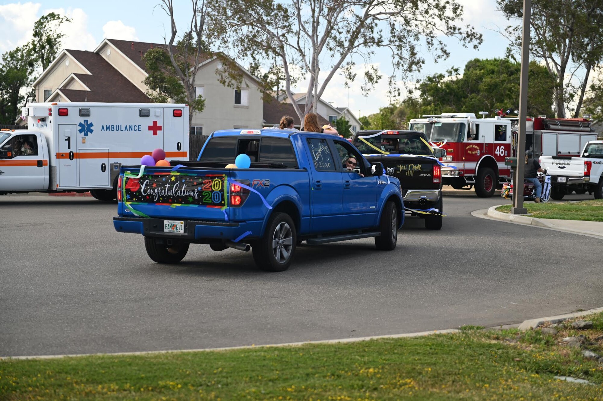 Members of the community drive across base to congratulate high school senior graduates during the “honk at a grad” parade, June 12, 2020, at Travis Air Force Base, California. The parade celebrated high school seniors unable to experience a graduation ceremony due to the COVID-19 pandemic. The event was a collaboration between the base’s local Air Force Sergeants Association Chapter 1320, Airman and Family Readiness Center, and chaplain corps. (U.S. Air Force photo by Airman 1st Class Karla Parra)