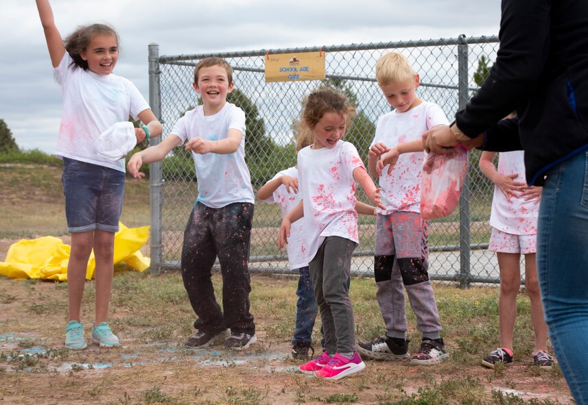 School Age Care program children wait to be covered in colored cornstarch after the SAC color run at Schriever Air Force Base, Colorado, June 19, 2020. After the run, SAC staff members had leftover cornstarch they used to make the children’s T-shirts more colorful. (U.S. Air Force photo by Airman 1st Class Amanda Lovelace)