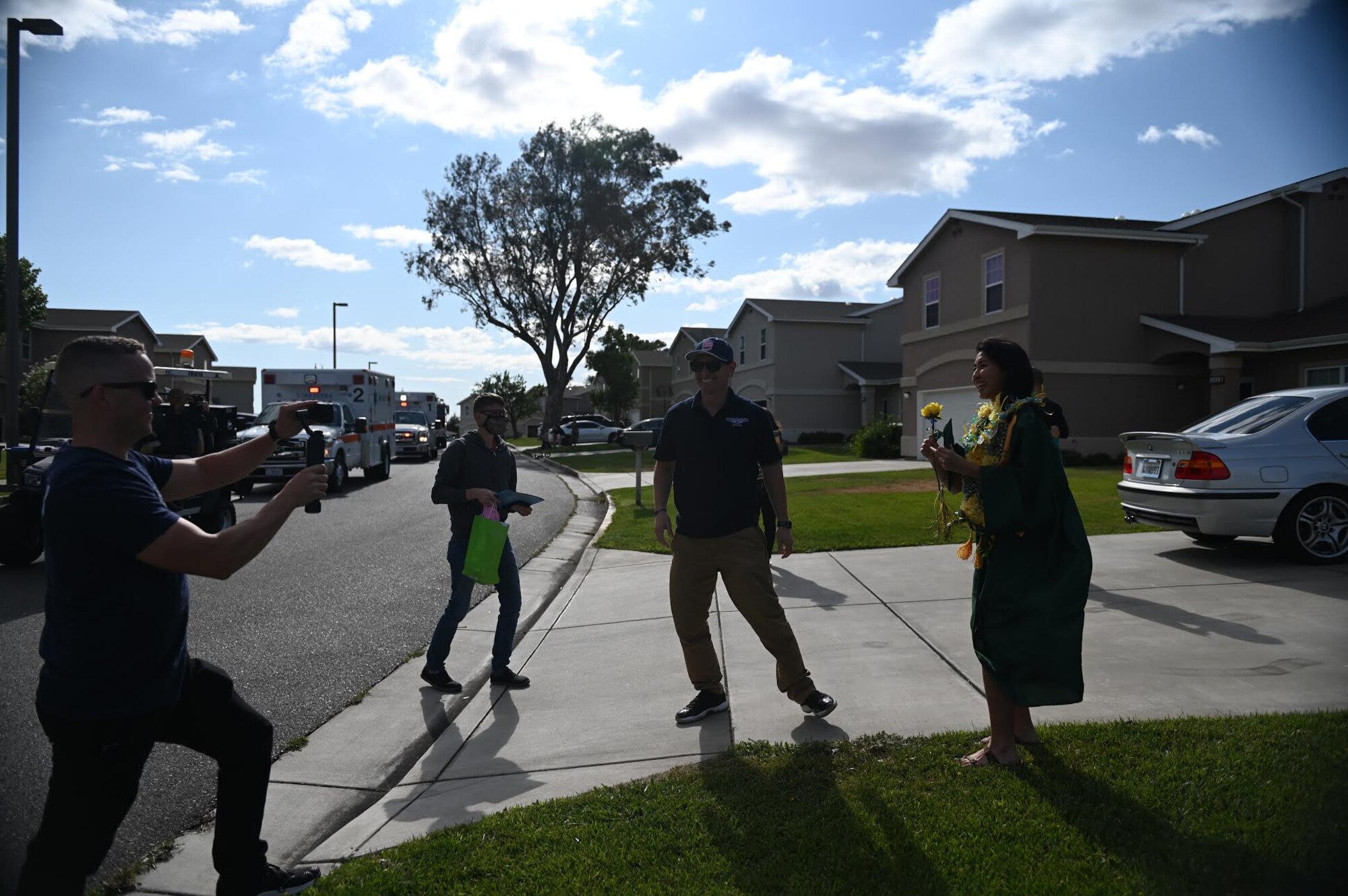 Members of the local Air Force Sergeants Association Chapter 1320 and the base’s chaplain corps give high school graduates mementos during the “honk at a grad” parade, June 12, 2020, at Travis Air Force Base, California. The event was a collaboration between the base’s local AFSA Chapter 1320, Airman and Family Readiness Center, and chaplain corps to celebrate high school graduates unable to experience a graduation ceremony during the COVID-19 pandemic. (U.S. Air Force photo by Airman 1st Class Karla Parra)