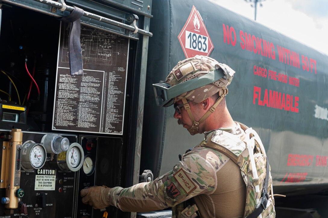 Photo of an Airman checking fuel gauges