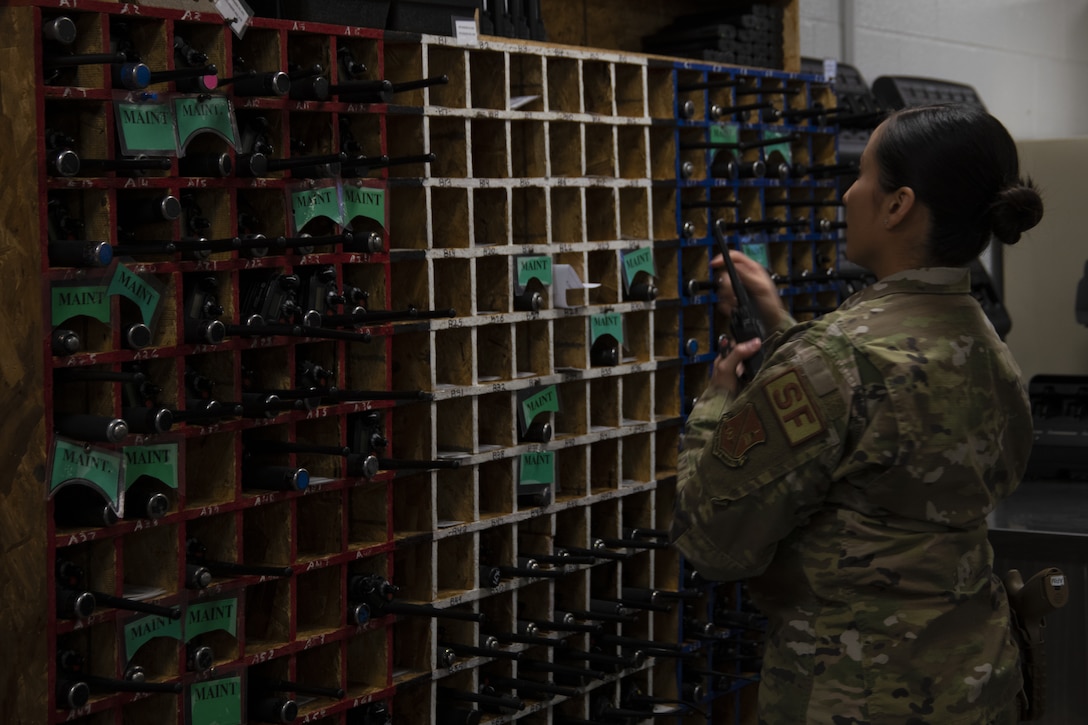 Senior Airman Cindy Argueta, 316th Security Support Squadron armorer, gets a two-way radio for a defender to use during their shift at Joint Base Andrews, Md., June 17, 2020. Radios allow for defenders to communicate with each other and the base defense operations center.