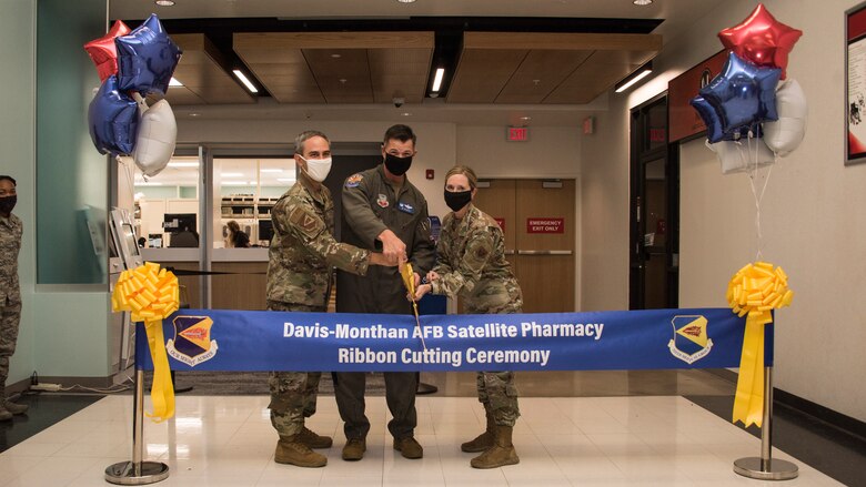 A photo of wing leadership cutting ribbon for new satellite pharmacy