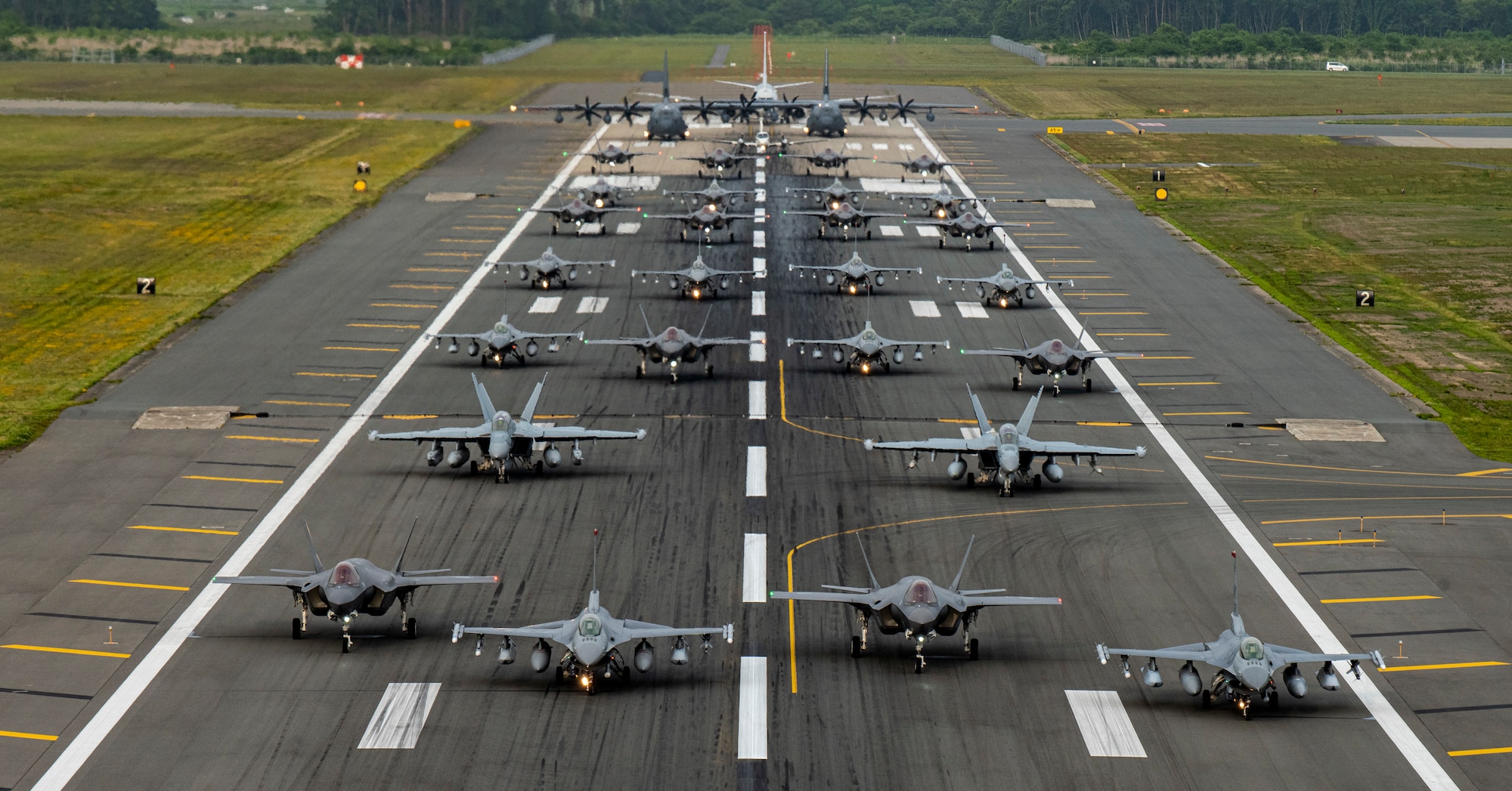 Twelve U.S. Air Force F-16CM Fighting Falcons, 12 Koku-Jieitai F-35A Lightning II Joint Strike Fighters, two U.S. Navy EA-18G Growlers, a USN C-12 Huron, two USAF MC-130J Commando II aircraft, and a USN P-8 Poseidon participate in an “Elephant Walk” at Misawa Air Base, June 22, 2020. The Elephant Walk showcased Misawa Air Base’s collective readiness and ability to generate combat airpower at a moment's notice to ensure regional stability throughout the Indo-Pacific. This is Misawa Air Base’s first time hosting a bilateral and joint Elephant Walk.