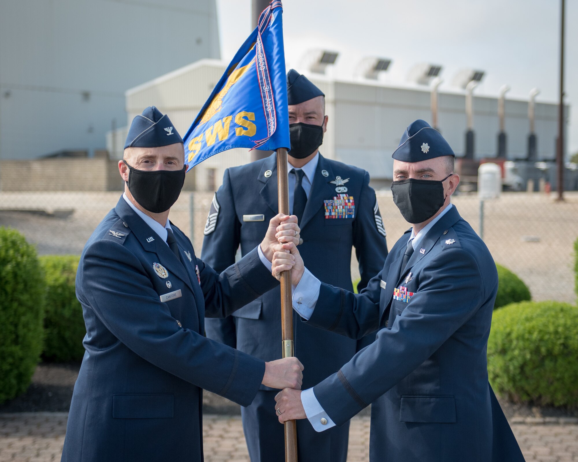 Lt. Col. Timothy C. Sheehan, new 6th Space Warning Squadron commander, accepts the unit guidon from Col. Matthew S. Cantore, 21st Operations Group commander during a change of command ceremony held at Cape Cod Air Force Station, Mass. on Jun 23, 2020.