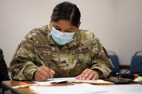 Oklahoma Army National Guard Sgt. Anna Aranda, a member of the 120th Forward Support Company, 45th Field Artillery Brigade, records answers on a privacy law-protected form as part of contact tracing operations at the the Texas County Health Department in Guymon, Oklahoma, May 15, 2020.