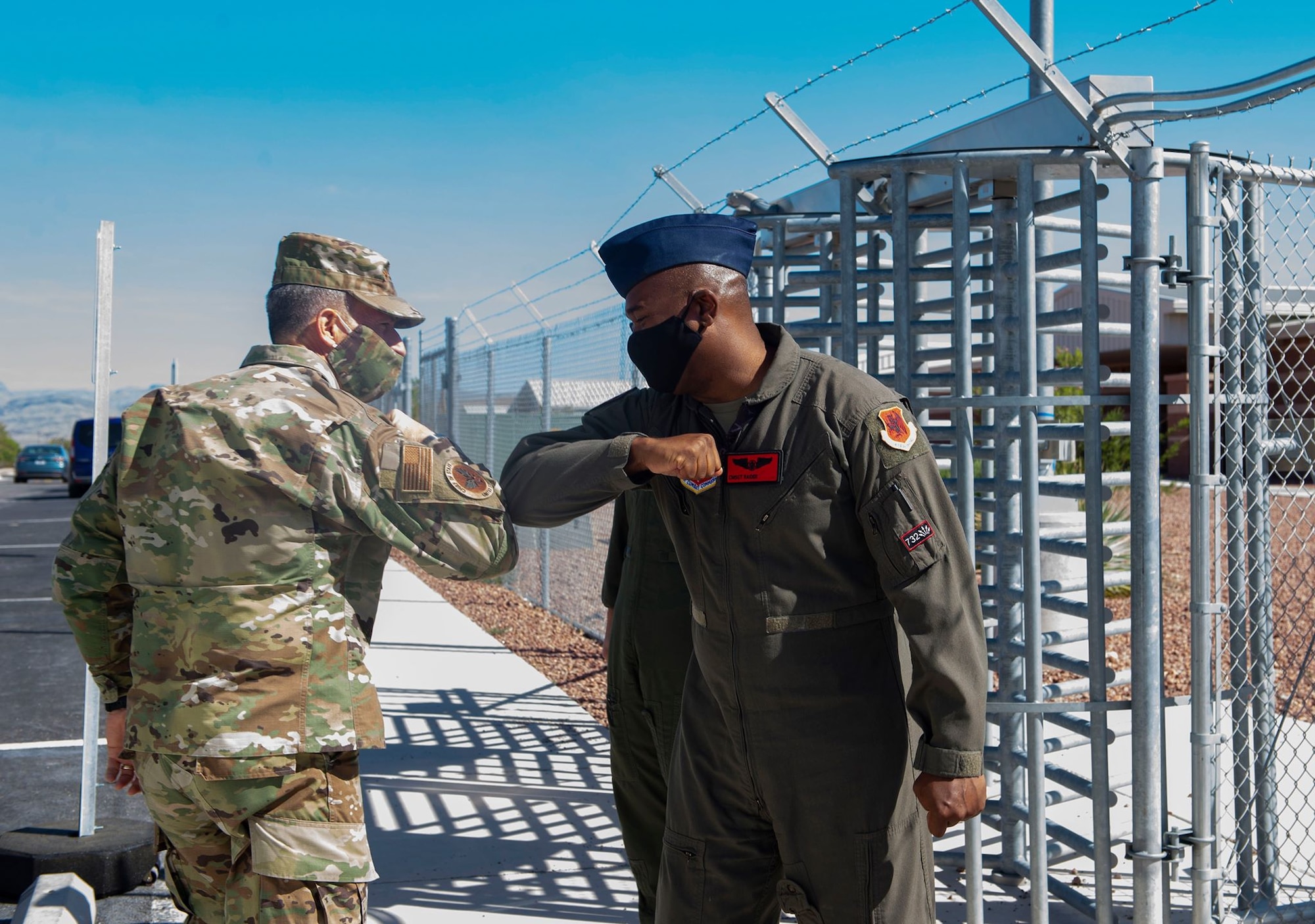 Air Force Chief of Staff Gen. David L. Goldfein greets Chief Master Sgt. Roderick with an elbow touch due to COVID-19 procedures outside of the 17th Attack Squadron.