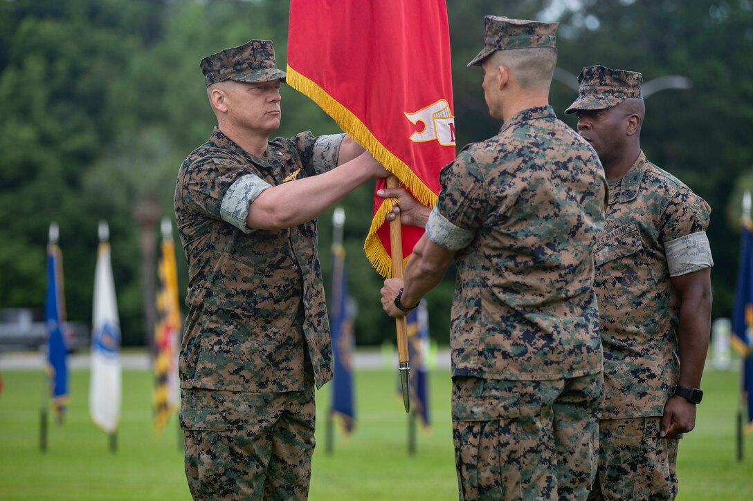 Col. Thimothy P. Miller relinquishes command to Col. Karl R. Arbogast at the station parade field, June 18.