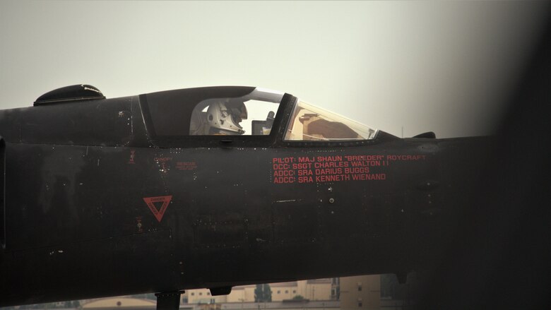 Lt. Col Georgescu situates himself inside the cockpit of the U-2 in his full pressure suit, preparing to taxi off of the runway.