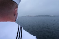 YOKOSUKA, Japan (June 24, 2020) - A Sailor dons a mask and mans the rails as U.S. 7th Fleet flagship, USS Blue Ridge (LCC 19) returns to Yokosuka, Japan May 24, 2020. Blue Ridge is the oldest operational ship in the Navy and, as 7th Fleet command ship, actively works to foster relationships with allies and partners in the Indo-Pacific region. (U.S. Navy photo by Mass Communication Specialist Seaman Matt Hall)