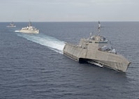 The Independence-variant littoral combat ship USS Gabrielle Giffords (LCS 10), right, exercises with the Japan Maritime Self-Defense Force training ships JS Kashima (TV 3508) and JS Shimayuki (TV 3513) in the South China Sea, June 23, 2020. Gabrielle Giffords, part of Destroyer Squadron Seven, is on a rotational deployment, operating in the U.S. 7th Fleet area of operations to enhance interoperability with partners and serve as a ready-response force.