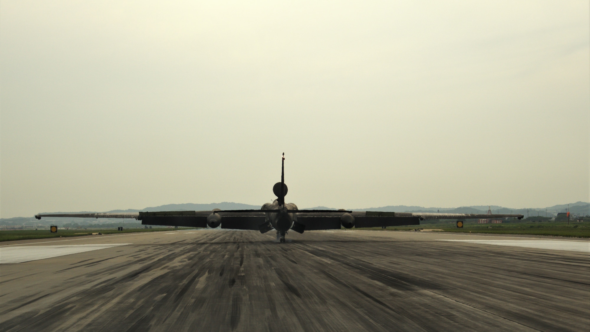 The U-2 touches down on the runway, completing a successful flight.