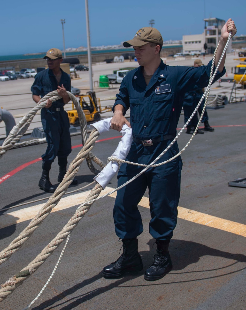 200623-N-KY668-1023 NAVAL STATION ROTA, Spain (June 23, 2020) Information System Technician 2nd Class Ryan T. Pieper heaves around a line on the foc’s’le aboard the Arleigh Burke-class guided-missile destroyer USS Roosevelt (DDG 80), June 23, 2020. Roosevelt, forward-deployed to Rota, Spain, is on its first patrol in the U.S. 6th Fleet area of operations in support of regional allies and partners and U.S. national security interests in Europe and Africa. (U.S. Navy photo by Mass Communication Specialist Seaman Austin G. Collins/Released)