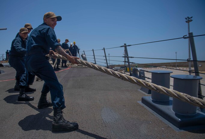 200623-N-KY668-1047 NAVAL STATION ROTA, Spain (June 23, 2020) Operations Specialist Seaman Recruit Mateo C. Betancourt heaves around a line on the foc’s’le aboard the Arleigh Burke-class guided-missile destroyer USS Roosevelt (DDG 80), June 23, 2020. Roosevelt, forward-deployed to Rota, Spain, is on its first patrol in the U.S. 6th Fleet area of operations in support of regional allies and partners and U.S. national security interests in Europe and Africa. (U.S. Navy photo by Mass Communication Specialist Seaman Austin G. Collins/Released)