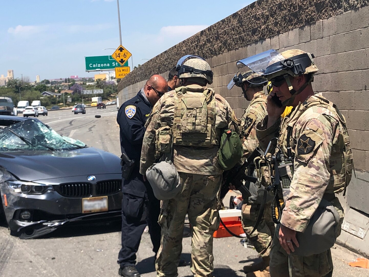 Soldiers with the California National Guard's 1st Battalion, 185th Infantry Regiment, responded to a car accident in Los Angeles June 2, 2020. Spc. Abdel Rahman Ali, 1-185th combat medic, assisted an injured civilian while other members of the team put out a brush fire caused by the accident and redirected traffic.