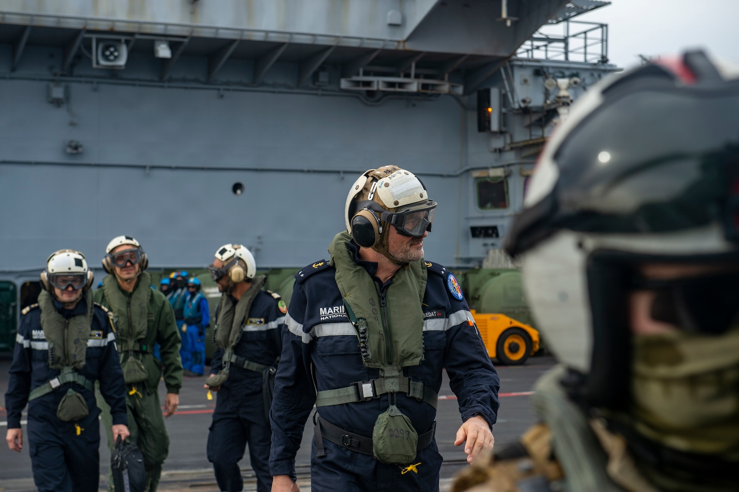 Rear-Admiral Marc Aussedat, commander, French Marine Nationale, walks across the flight deck of the French aircraft carrier FS Charles de Gaulle (R91) during an integrated operations exercise with aircraft carrier USS Dwight D. Eisenhower (CVN 69). Ike is conducting operations in the Mediterranean Sea as part of the USS Dwight D. Eisenhower Carrier Strike Group.