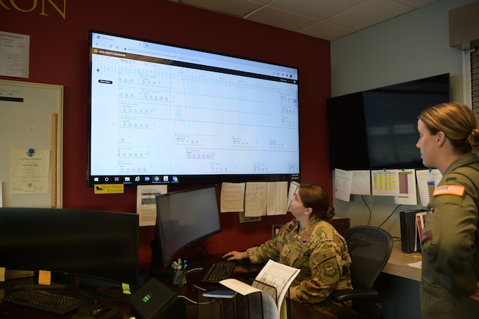 Capt. Kayla Gibson, left, and 1st Lt. Alex Osborn, pilots assigned to the 16th Airlift Squadron, review the squadron’s flight schedule on a new web-based platform at Joint base Charleston, S.C., June 18, 2020. The system was developed by the Airmen Coders, a group whose mission is to use coding to find modern solutions to the challenges today’s Airmen face. The web-based schedule allows aircrew members to remotely view upcoming missions and other important information. (U.S. Air Force photo by Senior Airman Joshua R. Maund)