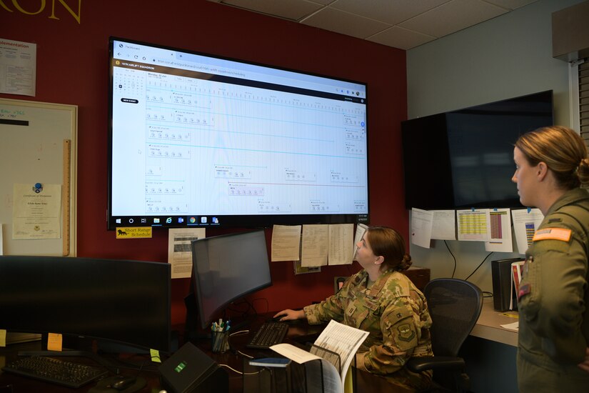 Capt. Kayla Gibson, left, and 1st Lt. Alex Osborn, pilots assigned to the 16th Airlift Squadron, review the squadron’s flight schedule on a new web-based platform at Joint base Charleston, S.C., June 18, 2020. The system was developed by the Airmen Coders, a group whose mission is to use coding to find modern solutions to the challenges today’s Airmen face. The web-based schedule allows aircrew members to remotely view upcoming missions and other important information. (U.S. Air Force photo by Senior Airman Joshua R. Maund)