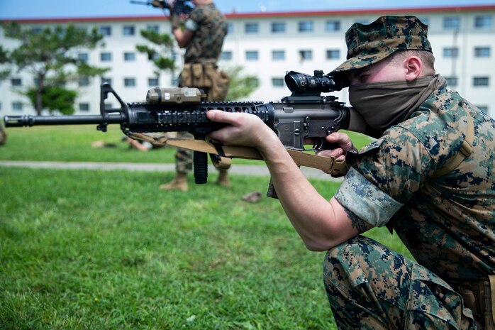 A U.S. Marine practices marksmanship fundamentals from the kneeling position with an M16A4 service rifle on Camp Hansen, Okinawa, Japan, May 7.